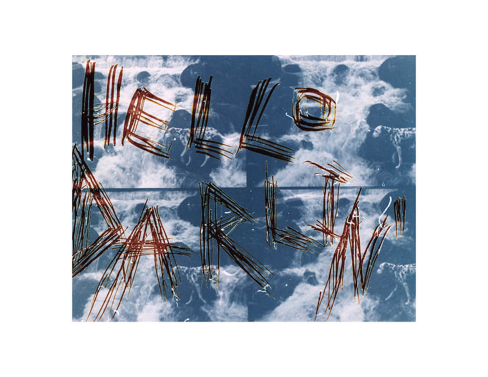 an abstract fine art color darkroom print of an image with the words hello darlin scratched into it layered with an image of four sequential images of a Dalmatian next to a waterfall