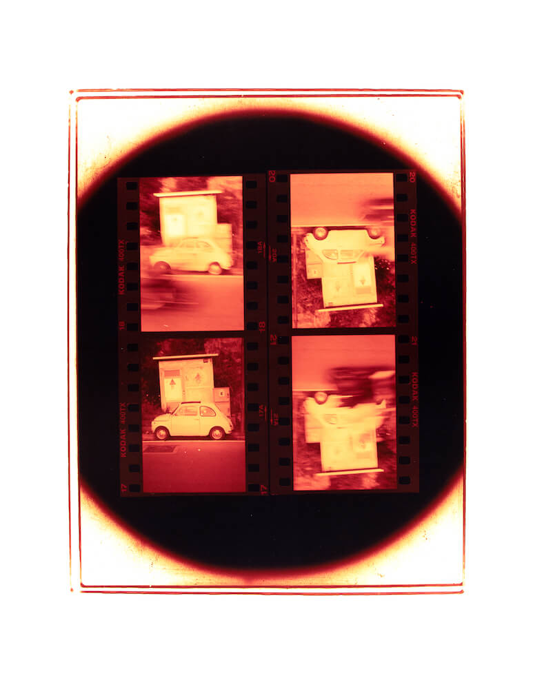 a color darkroom print of four 35mm negatives depicting a car in Positano Italy surrounded by a circular enlarger silhouette